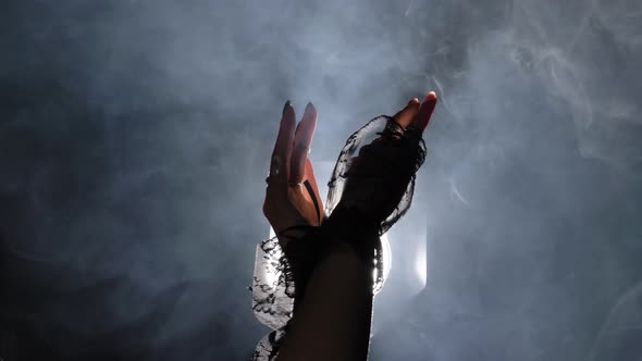 Mysterious Mysterious Dance of Women's Hands in the Smoke Opposite the Light alt
