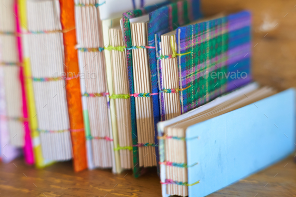 Closeup shot of books with colorful covers bound with rubber bands
