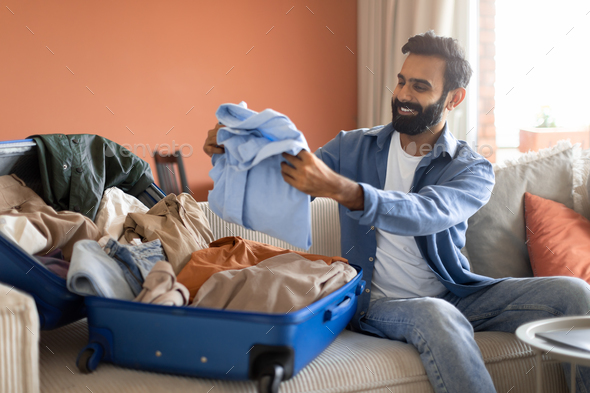 man packing suitcase