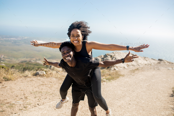 Young Man Giving Woman Piggyback Outdoors, Stock image