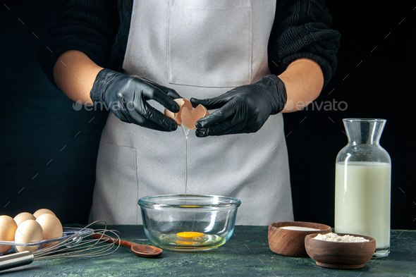 front view female cook breaking eggs for dough on dark background pastry job cake pies worker