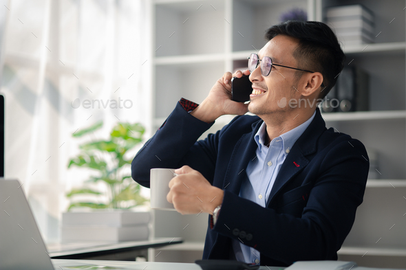 Man working in office and talking on the phone, he is young businessman, modern business management,