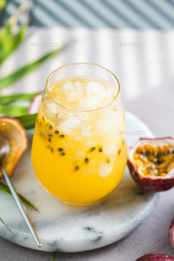 Glass of Iced passion fruit soda with lemon and passion fruit half ...