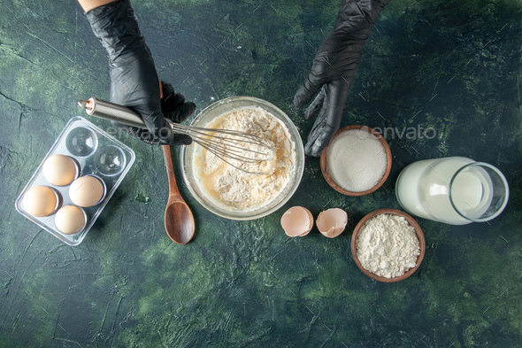 top view female cook mixing up flour in plate with eggs on dark background pastry cake pie worker