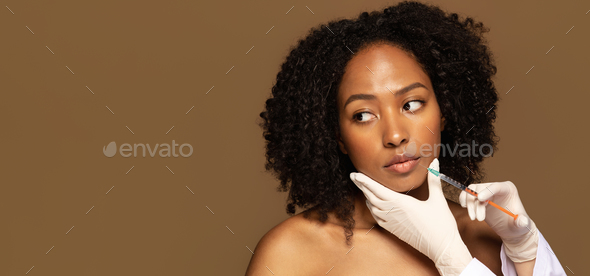 Attractive millennial african woman get lip filler injection, web-banner