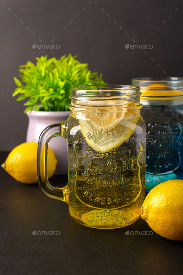 a front view lemon cocktail fresh cool drink inside glass cups sliced  lemons on the dark background Stock Photo by ImgSolut