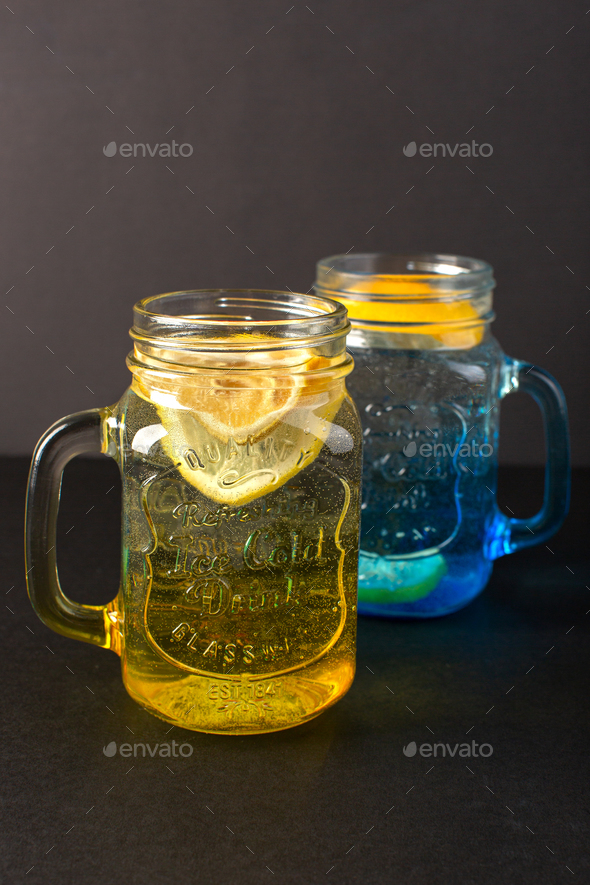 a front view lemon cocktail fresh cool drink inside glass cups sliced  lemons on the dark background Stock Photo by ImgSolut