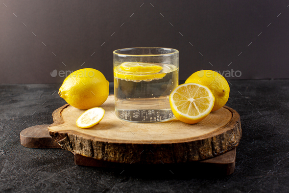 https://s3.envato.com/files/453898399/a_front_view_(water_with_lemon)_fresh_cool_drink_with_sliced_lemons_alogn_with_whole_lemons_inside_transparent_glasses_on_the_dark_background_cocktail_drink_fruit.jpg