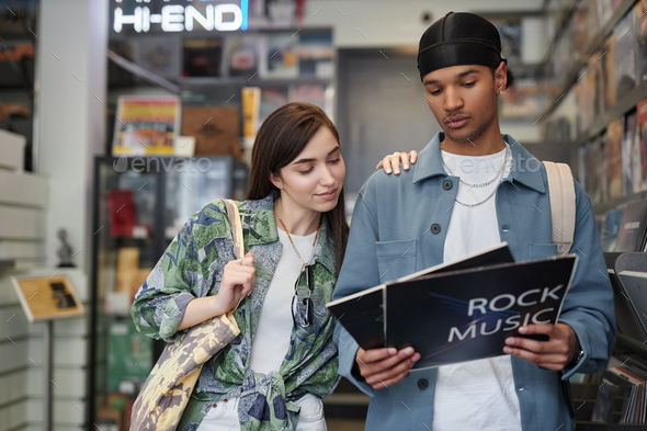 Young couple choosing vinyl records in record store