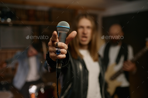 Man rocker wearing style with black jacket and white t-shirt with microphone