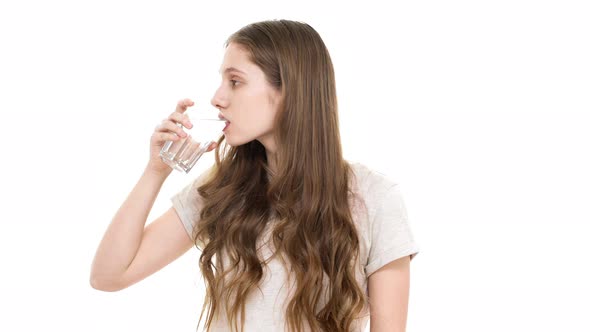 Portrait of Goodlooking Teenage Girl with Brown Hair Being Dehydrated and Drinking Mineral Water alt