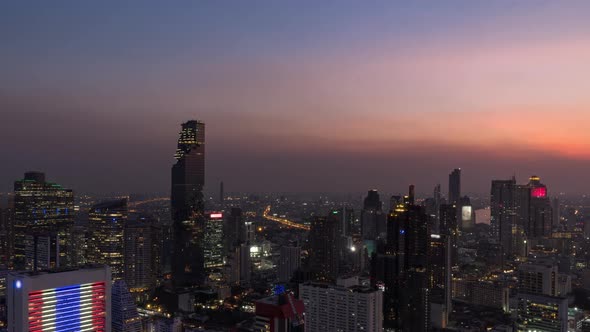 Bangkok business district city center above Silom area, day to night; zoom in – Time Lapse