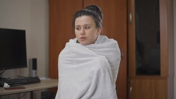 Young Ill Woman Wrapping in Blanket Shivering Looking Around Indoors at Home alt