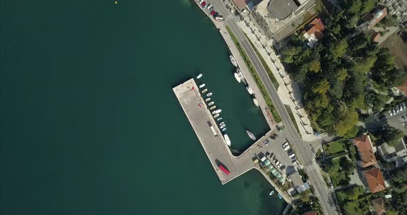 A small port on the bay of Kotor. Birds eye aerial view of the shoreline in Risan, Montenegro. alt