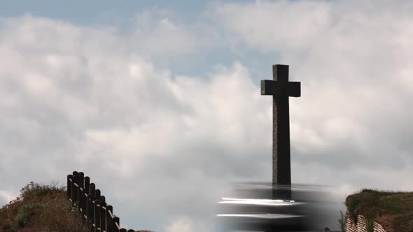 Zooming in timelapse of a village stone cross memorial with beautiful blue sky and cloudsing in the alt