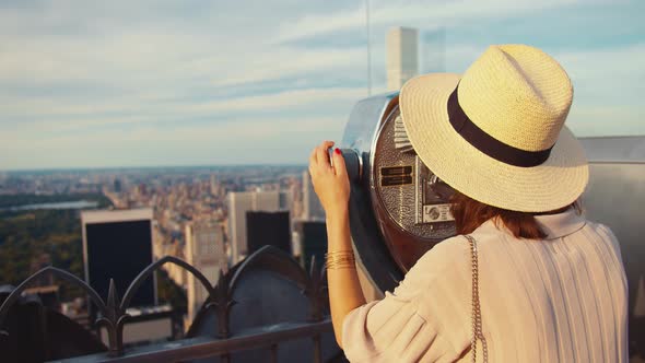 Young woman looking through binoculars alt