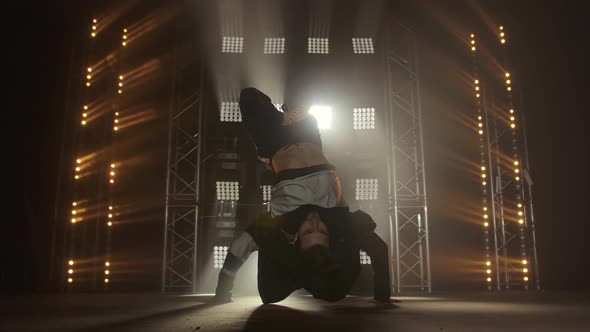 Breakdance Concept. Trendy Young Man Dancing Single in Club, Neon Light, Lots of Smoke. Fashion alt