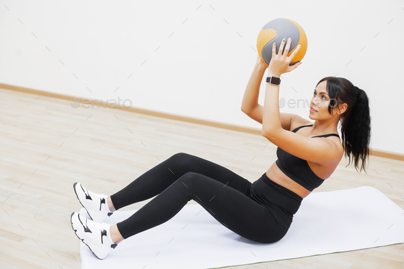 Fitness Girl. Sexy athletic girl working out in gym. Fitness woman doing  exercise Stock Photo by maksymiv