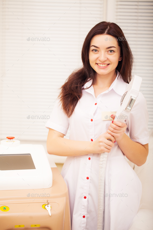 Body Care. Woman doctor displaying machine for laser hair removal