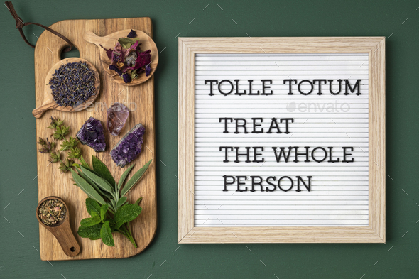 Letter board with text Tolle totum meaning treat the whole person in latin. Naturopatical principle