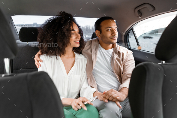 Arab Husband And Wife Sitting On Back Seat In Car