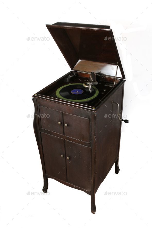 Antique vintage record player and a vinyl record album isolated on a white background.