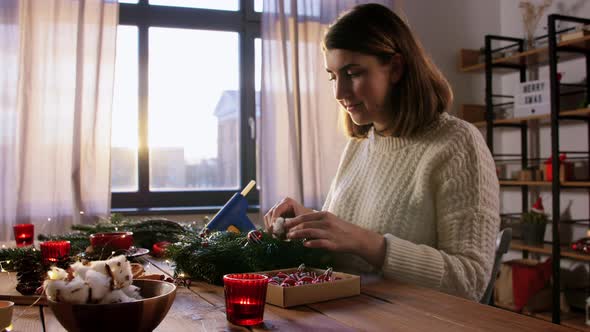 Happy Woman Making Fir Christmas Wreath at Home alt