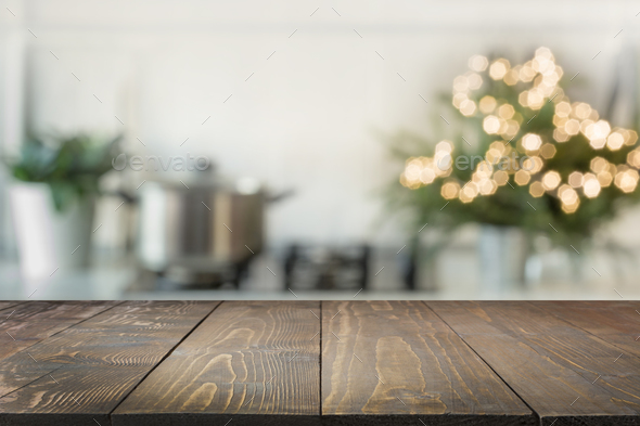 Premium Photo  Wooden tabletop with cutting board and blurred kitchen with  christmas tree background for display or montage your products