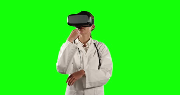 Front view of female doctor using virtual reality with green screen alt