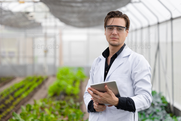 Portrait Scientist male researcher staff worker collecting study plant information in agriculture fa