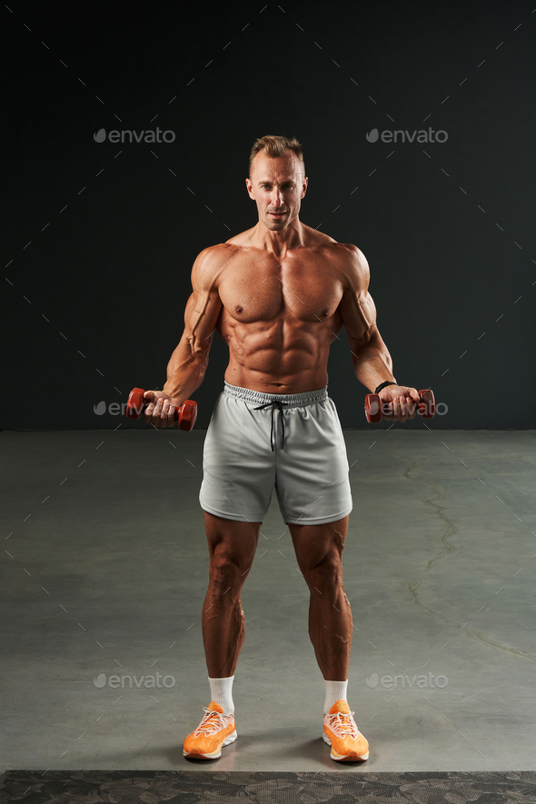 ideal press cubes for a caucasian athlete with a naked torso in some shorts. playing sports with