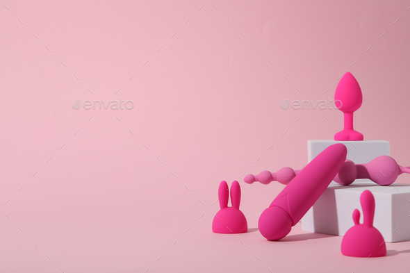 Composition of pink sex toys with cubes on a pink background Stock  