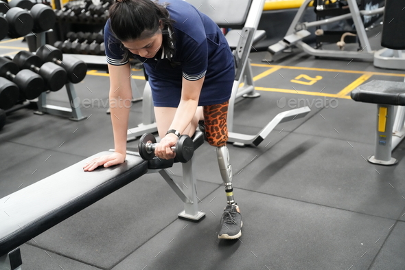 Stay active, Young woman with bionic leg exercise in fitness. healthy and sport concept.
