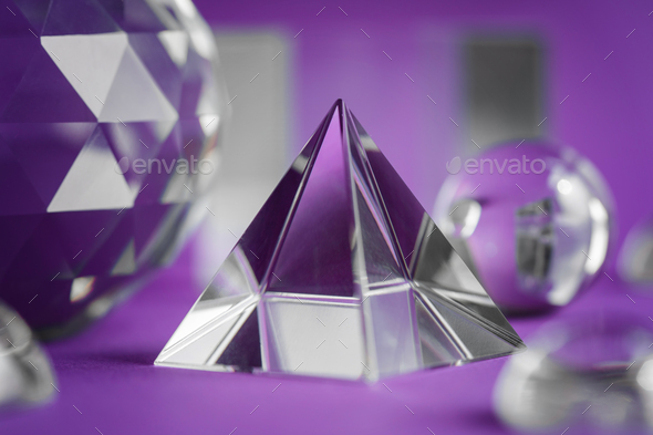 Crystal prism refracting light, magic crystals and pyramid, sphere and cube on purple background