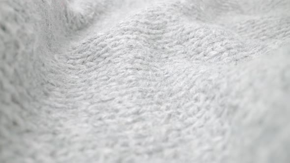 Extreme detail view of sheep wool cloth texture flowing in macro dolly shot. alt