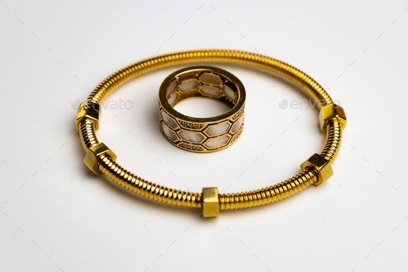 Stunning gold-toned bracelet featuring a circular ring on the white background