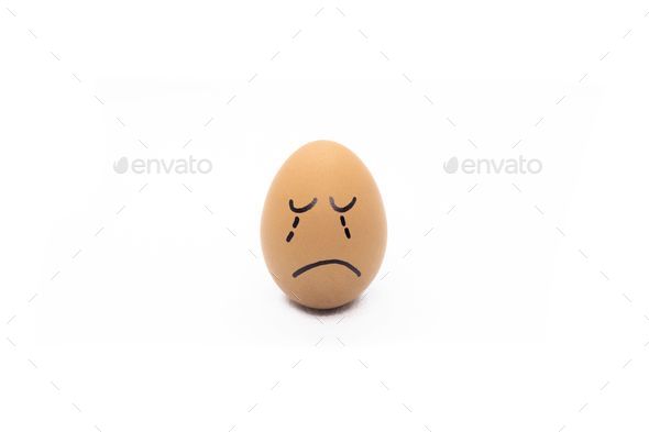 an egg with a drawn crying face isolated on a white background