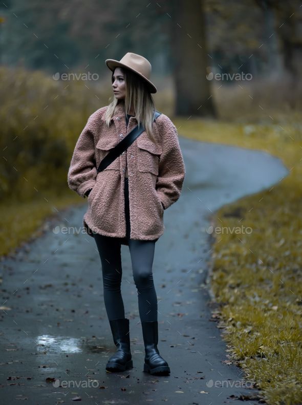 Girl in a stylish autumn outfit consisting of a dirty pink jacket