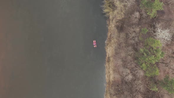 AERIAL: Kayakers Swimming Close to Each Other on a River in Early Spring Time