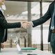 Two businesspeople shaking hands in the office - PhotoDune Item for Sale