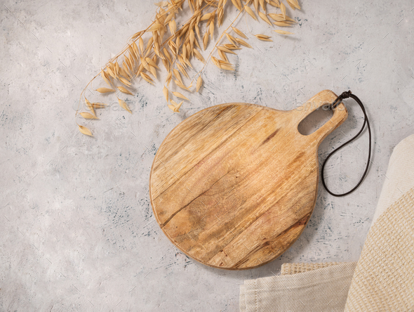 Empty wooden cutting board on a kitchen table. Top view, copy