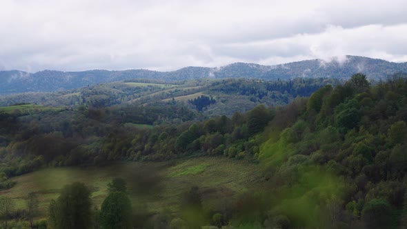 green mountains with cloudy sky  alt
