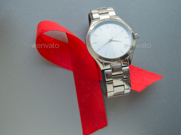 World AIDS day, the symbol of the red ribbon and the clock - do not waste time to start treatment