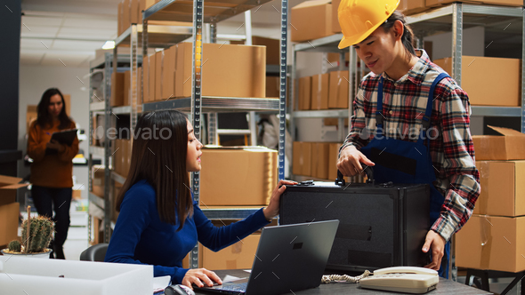 Business owner working on stock logistics with employee