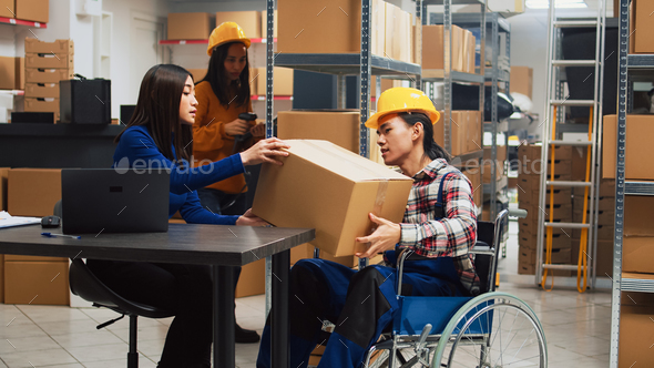 Asian guy organizing boxes with supplies on shelves Stock Photo by DC_Studio