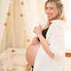 Young pregnant woman in the baby room - PhotoDune Item for Sale