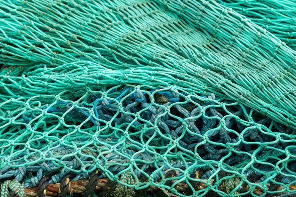 Tangled up nylon fishing nets Stock Photo by wirestock