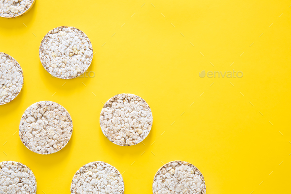 Creative layout made of rice cakes on the yellow background, flat lay.