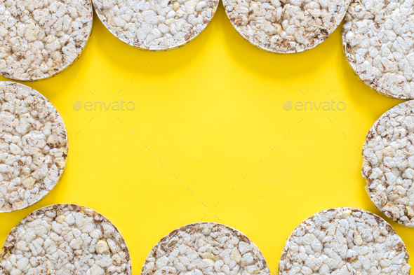 Creative layout made of rice cakes on the yellow background, flat lay.