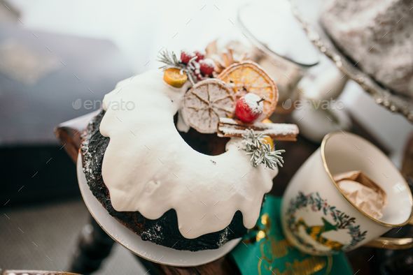 Festive holiday scene featuring a decorated cake on a platter in a Christmas-decorated setting